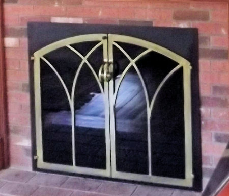 Taunton Square to Arch black frame with painted antique brass finish on twin doors, standard smoked glass. Comes with slide mesh spark screen.